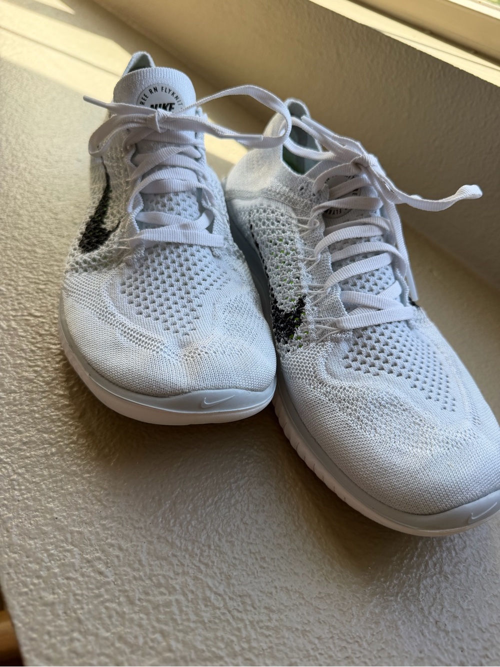 Nike Women’s White Flyknit Athletic Shoes with Black Swoosh